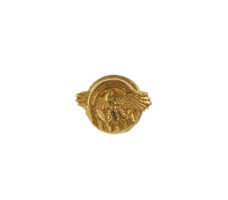 Small gold circular honorable service pin with image of eagle with outstretched wings in center
