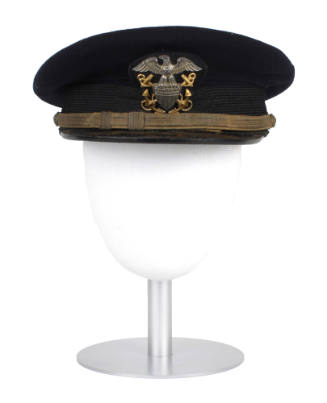 U.S. Navy officer combination cap with navy blue cover, displayed on a mannequin head form