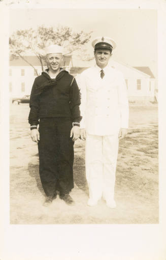 Printed black and white photograph of an enlisted sailor and an officer