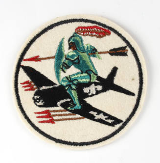 Round insignia patch depicting green knight riding on a black airplane with white background