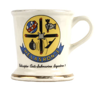 White ceramic mug with squadron insignia design