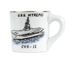 White ceramic mug with image of USS Intrepid at sea on one face 