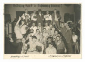 Printed postcard with black and white photograph of a group of sailors on liberty with men in G…