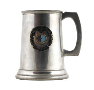 Pewter tankard with handle and central USS Intrepid insignia seal encircled by raised banners a…