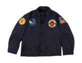 Front of dark blue USS Intrepid cruise jacket with various patches on the chest and shoulders