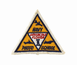 Triangular yellow and blue fabric patch from Navy Photo School