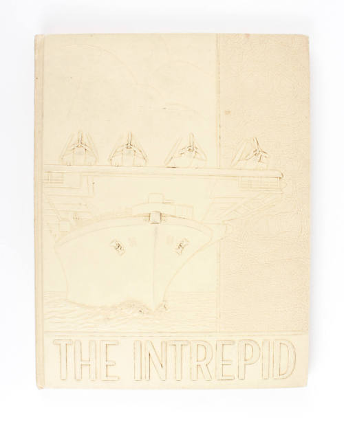 Tan hardcover USS Intrepid cruise book for 1943 with a raised image of Intrepid and aircraft on…