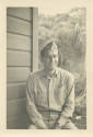 Printed black and white photograph of Donald Freet in a khaki uniform sitting outside