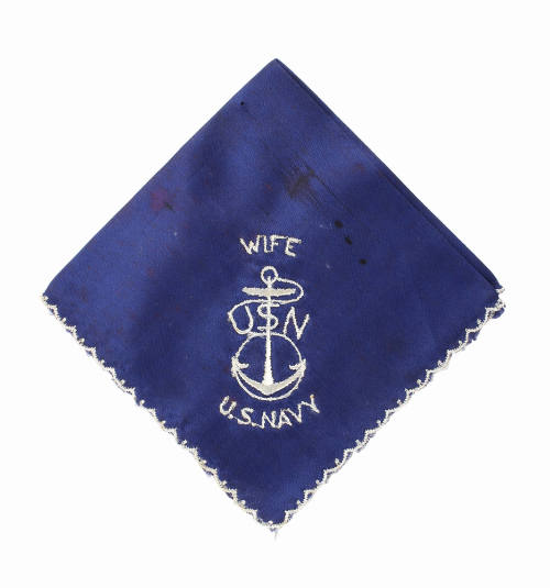 Folded square blue silk handkerchief with image of an anchor