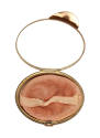 Oval makeup compact open to show mirror in top section and powder applicator in bottom