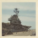 Color photograph of USS Intrepid docked in a port