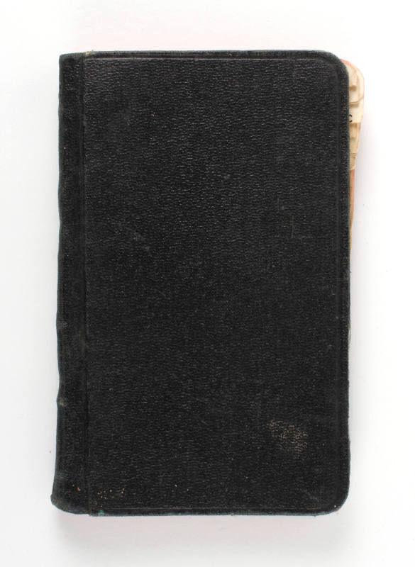 Black leather notebook with some pages visible on the edge