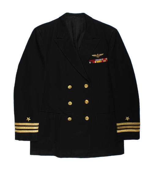 Front of dark blue U.S. Navy officer jacket with three stripes on sleeve cuffs, and ribbon bar …