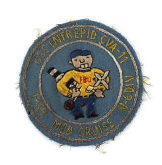 Blue circular patch with yellow stiching of a man wearing a yellow shirt and holding various to…