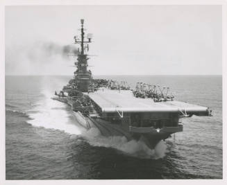 Black and white photograph of the aircraft carrier USS Intrepid at sea with airplanes parked on…