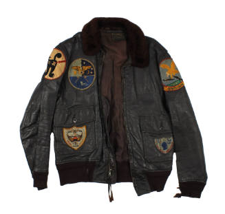 Front of brown leather flight jacket with fur collar and various insignia patches