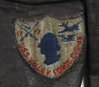 Shield shaped insignia patch with a silhouette of George Washington's head