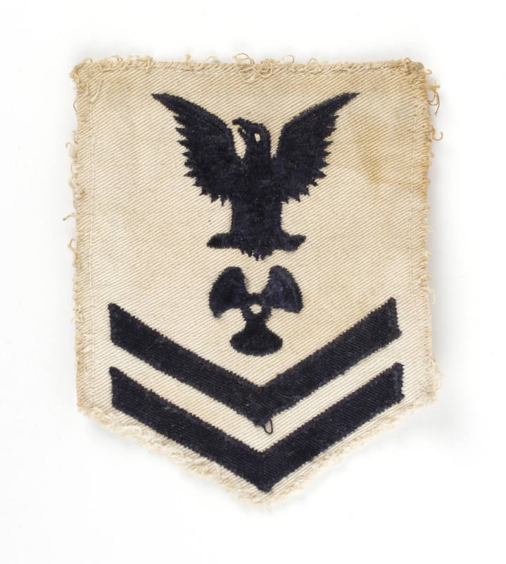 White U.S. Navy uniform patch with dark blue eagle, chevrons and image of a three-bladed propel…