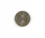 Face of rapid transit token with "good for one full fare" in raised text and six cut outs in co…