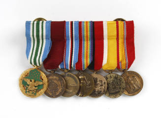 Front view of seven mini U.S. military medals with various colorful ribbons and medal designs