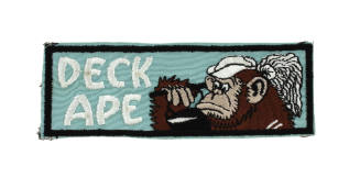 Bluish-green liberty cuff patch with embroidered image of ape with mop and bucket