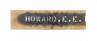 Brown stencil with black paint over cut-out letters spelling "Howard, E.E."